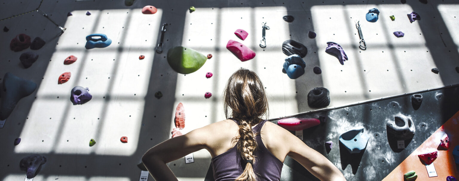 Person climbing indoor rock wall